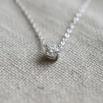Solitaire necklace on linen
