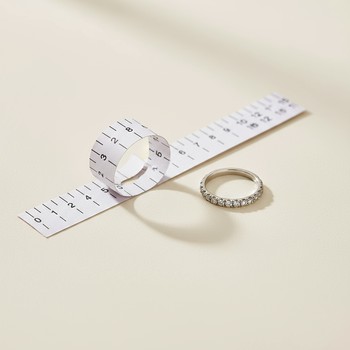 Paper strip ring sizer wrapped around a finger